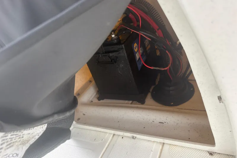 Slide: The Image of Battery compartment of 2023 Mako Pro Skiff 17 CC with wiring and connections. - 16
