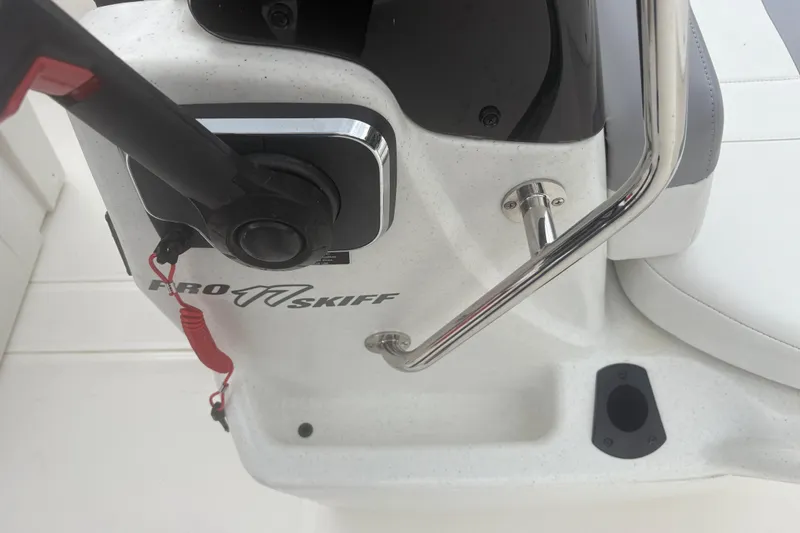 Slide: The Image of 2023 Mako Pro Skiff 17 CC boat console with throttle and safety lanyard. - 18