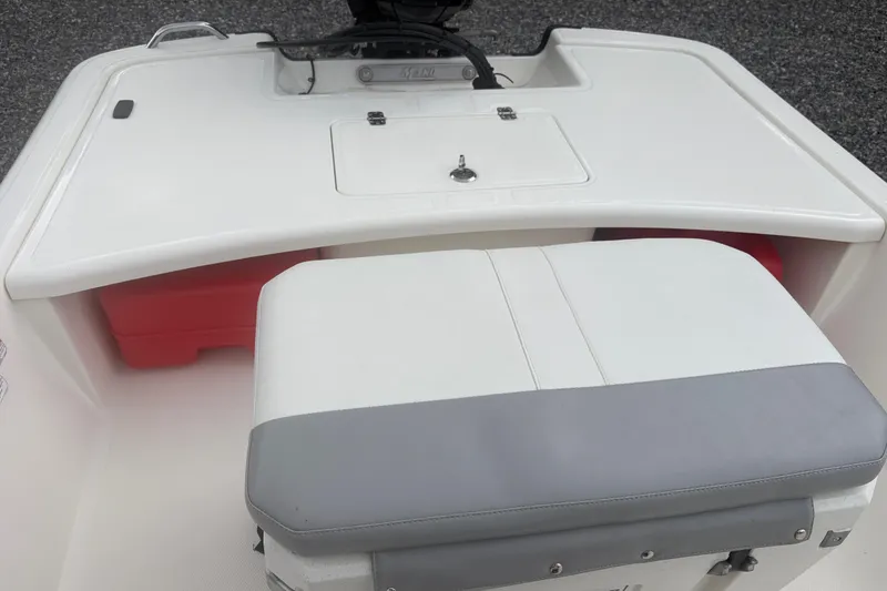 Slide: The Image of 2023 Mako Pro Skiff 17 CC boat interior with seating and storage compartments. - 19
