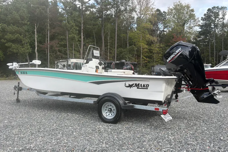 Slide: The Image of 2023 Mako Pro Skiff 17 CC boat with Mercury engine on trailer. - 2
