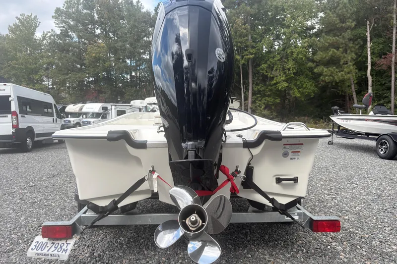 Slide: The Image of 2023 Mako Pro Skiff 17 CC boat on trailer, rear view with outboard motor. - 3