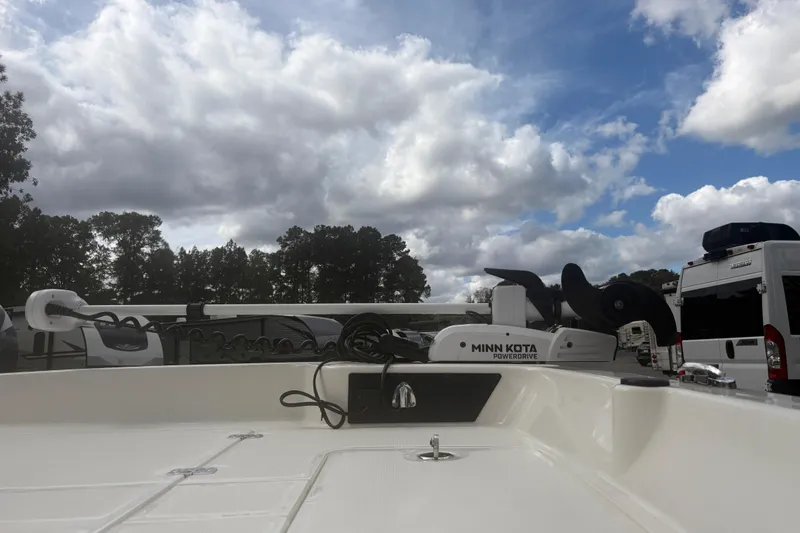 Slide: The Image of 2023 Mako Pro Skiff 17 CC with Minn Kota motor under cloudy sky. - 6