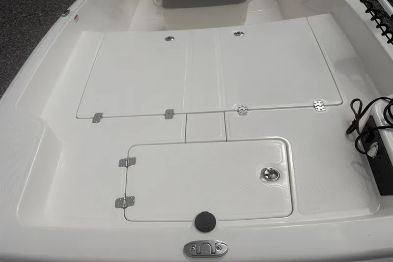 Slide: The Image of 2023 Mako Pro Skiff 17 CC boat deck with storage compartments. - 7