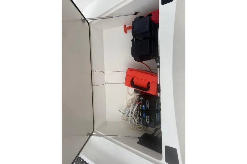 Slide: The Image of Storage compartment of 2023 Mako Pro Skiff 17 CC with equipment and supplies. - 8