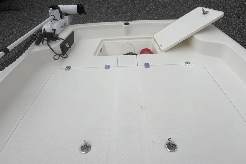 Slide: The Image of 2023 Mako Pro Skiff 17 CC boat deck with storage compartments and trolling motor. - 9