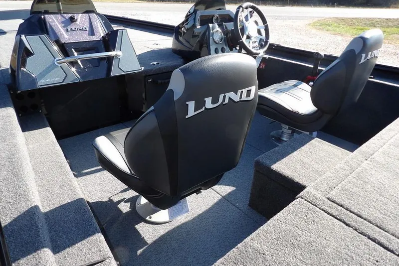 Slide: The Image of Interior of 2026 Lund 1975 Renegade boat with branded seats and steering console. - 13