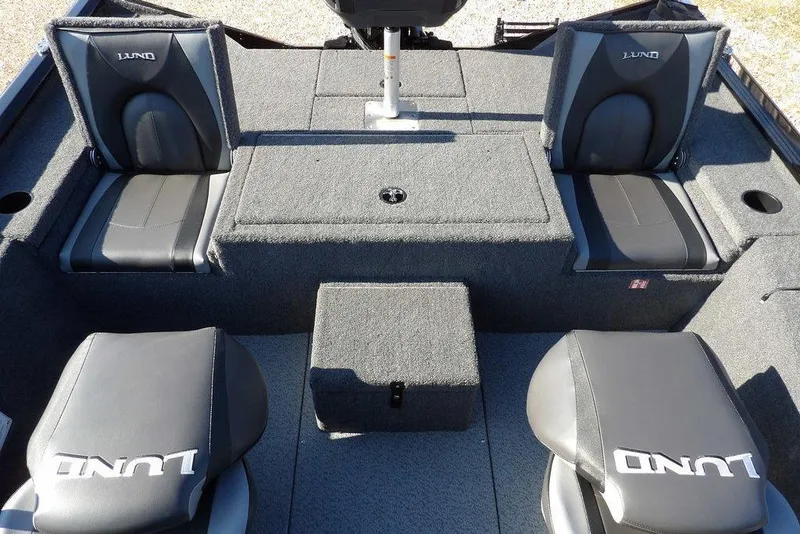 Slide: The Image of Interior of 2026 Lund 1975 Renegade boat with gray seating and storage compartments. - 14