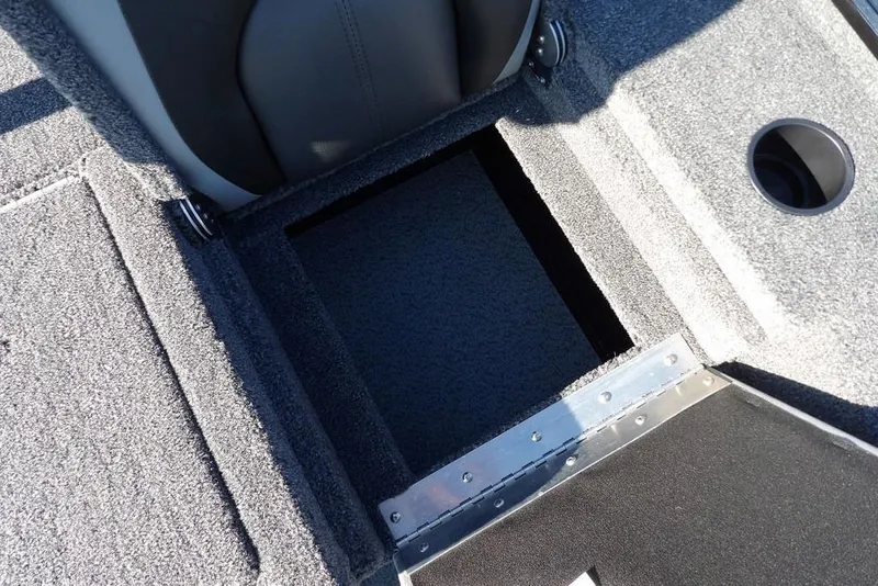 Slide: The Image of Interior view of 2026 Lund 1975 Renegade boat, featuring carpeted storage compartment. - 17