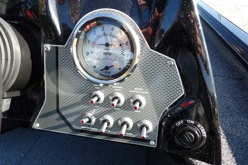 Slide: The Image of Dashboard of 2026 Lund 1975 Renegade boat with RPM gauge and control switches. - 27