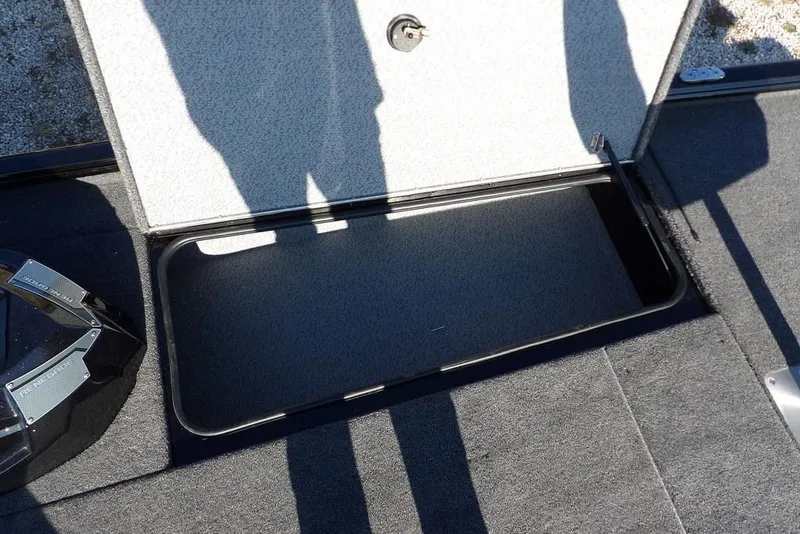 Slide: The Image of Open storage compartment on 2026 Lund 1975 Renegade boat deck. - 35