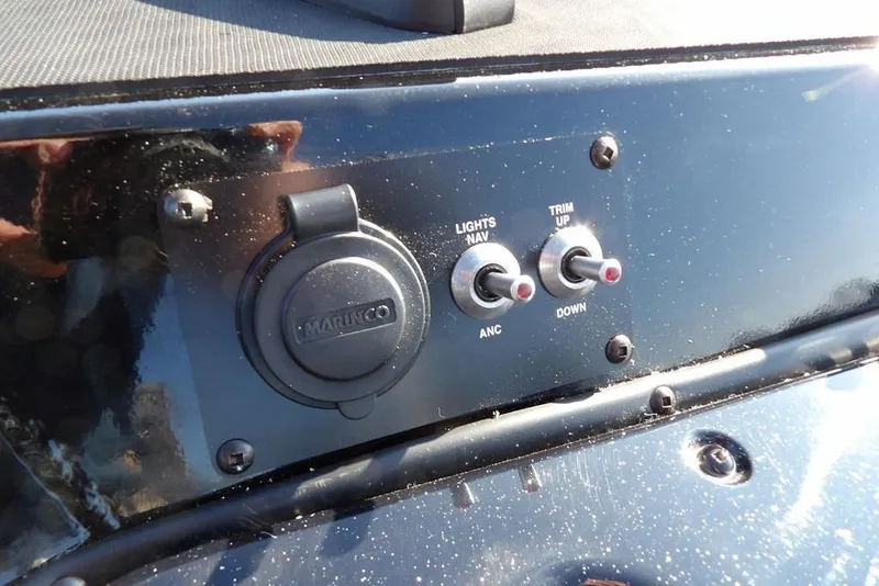 Slide: The Image of Control panel of 2026 Lund 1975 Renegade boat with switches and Marinco socket. - 42