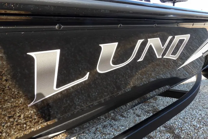 Slide: The Image of Close-up of 2026 Lund 1975 Renegade boat logo on black surface. - 44