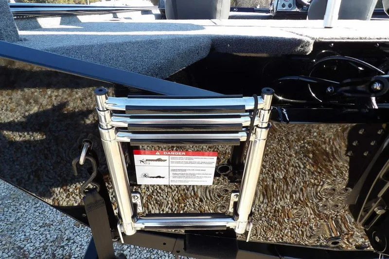 Slide: The Image of Lund 1975 Renegade 2026 boat with a folded metal ladder and warning label. - 47