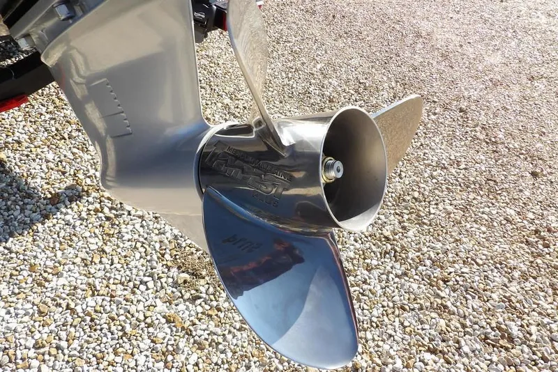 Slide: The Image of Propeller of 2026 Lund 1975 Renegade boat on gravel surface. - 48