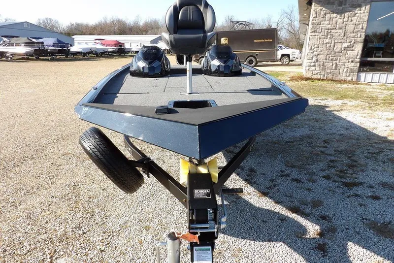 Slide: The Image of 2026 Lund 1975 Renegade boat on trailer, outdoor display, gravel lot. - 8