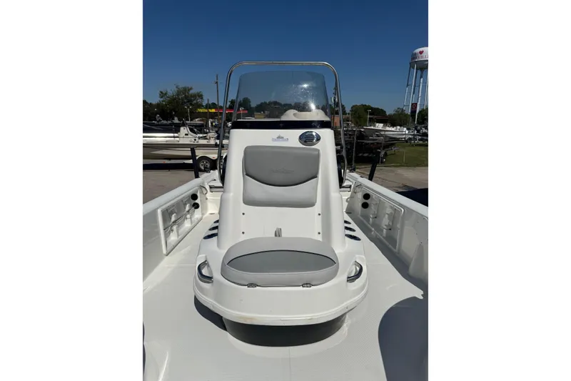 Slide: The Image of 2021 NauticStar 215 XTS Shallow Bay boat interior with seating and console, outdoors. - 12