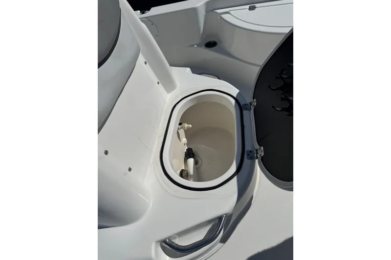 Slide: The Image of 2021 NauticStar 215 XTS Shallow Bay boat storage compartment open. - 13