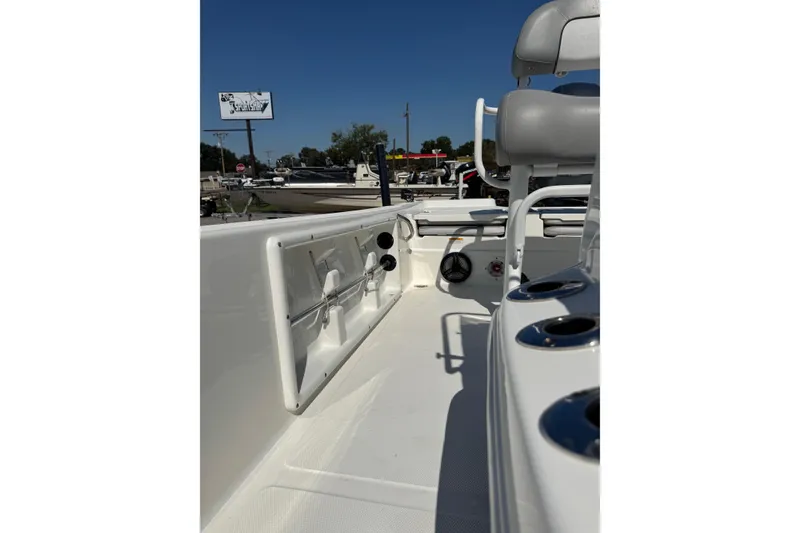 Slide: The Image of 2021 NauticStar 215 XTS Shallow Bay boat interior with seating and rod holders. - 15