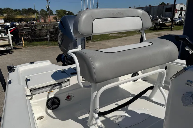 Slide: The Image of 2021 NauticStar 215 XTS Shallow Bay boat interior with cushioned seating and storage. - 16