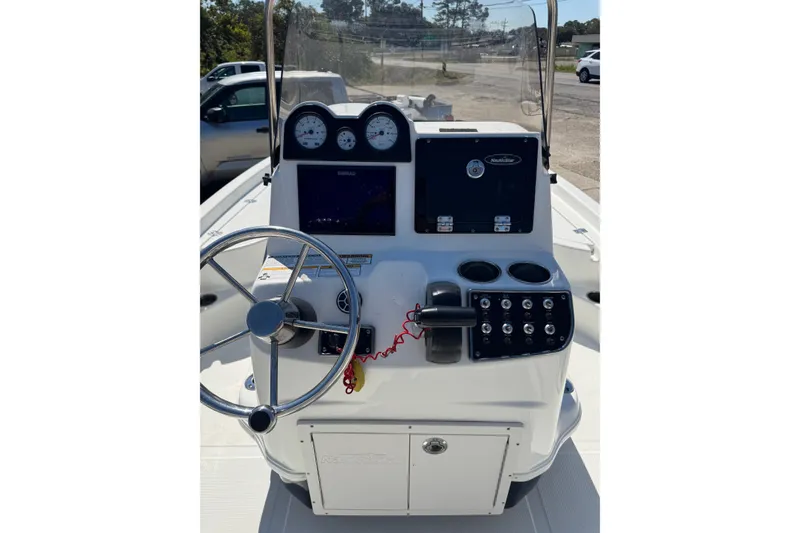 Slide: The Image of 2021 NauticStar 215 XTS Shallow Bay boat console with steering wheel and gauges. - 17