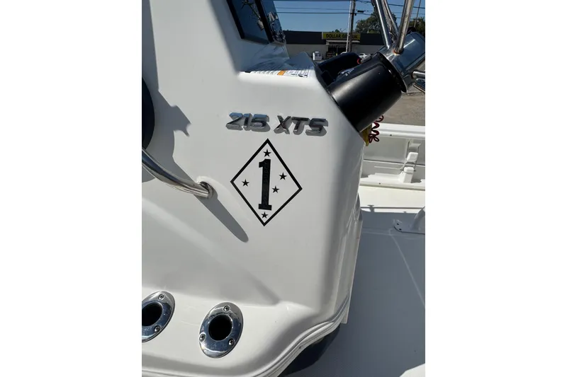 Slide: The Image of 2021 NauticStar 215 XTS Shallow Bay boat console with model emblem and decorative sticker. - 22