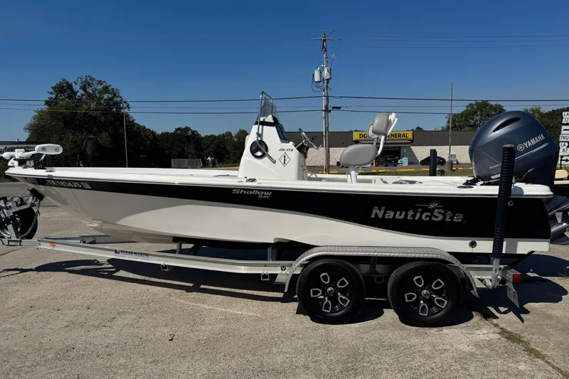 Slide: The Image of 2021 NauticStar 215 XTS Shallow Bay boat on trailer, side view. - 3