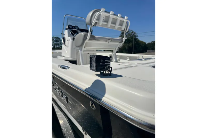 Slide: The Image of 2021 NauticStar 215 XTS Shallow Bay boat with fishing rod holders and equipment. - 5