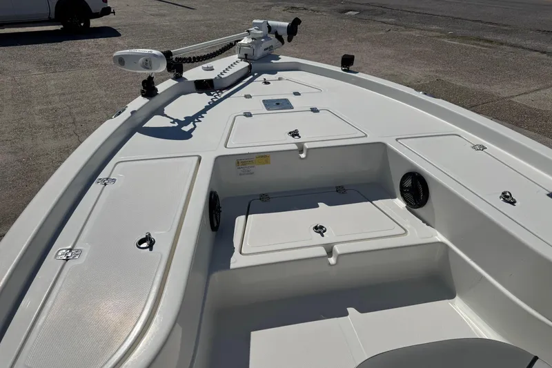 Slide: The Image of 2021 NauticStar 215 XTS Shallow Bay boat deck with storage compartments and trolling motor. - 8