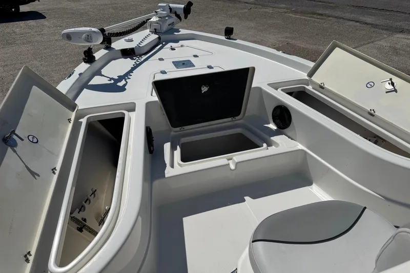 Slide: The Image of 2021 NauticStar 215 XTS Shallow Bay boat interior with open storage compartments. - 9
