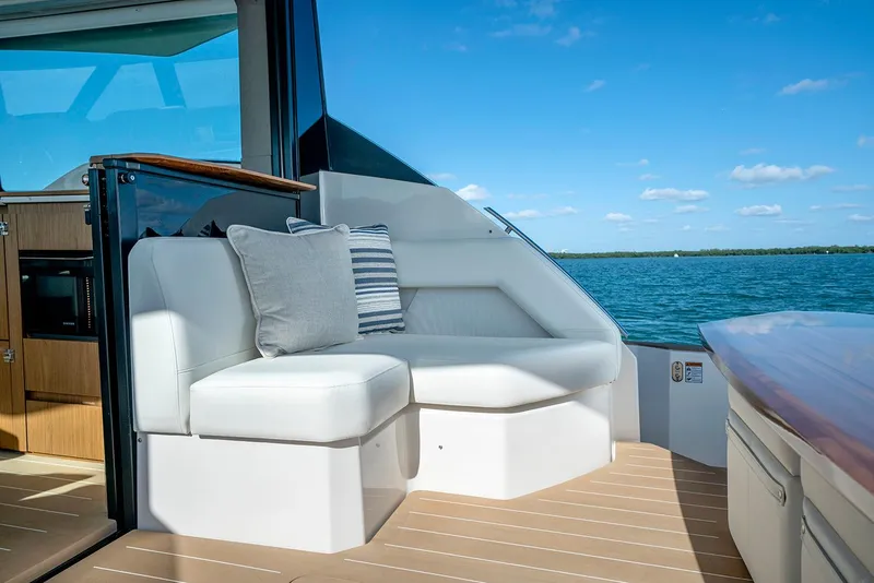 Slide: The Image of 2024 Tiara Yachts EX 60 on water, featuring radar domes and clear blue sky. - 13