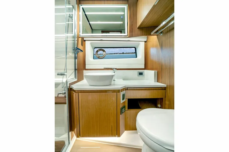 Slide: The Image of 2024 Tiara Yachts EX 60 outdoor kitchen with grill and sink by the water. - 23