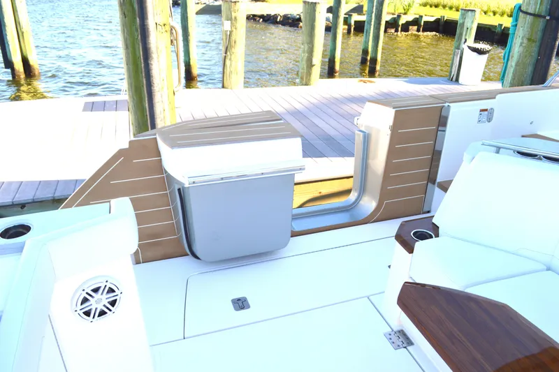 Slide: The Image of 2024 Tiara Yachts EX 60 deck with seating and dock view. - 27