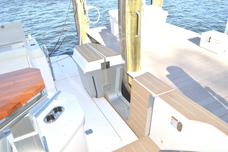 Slide: The Image of 2024 Tiara Yachts EX 60 docked, showcasing deck and seating area by the water. - 28