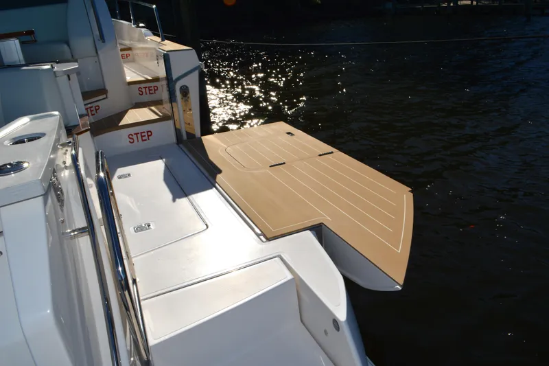 Slide: The Image of 2024 Tiara Yachts EX 60 swim platform and steps, docked by the water. - 29