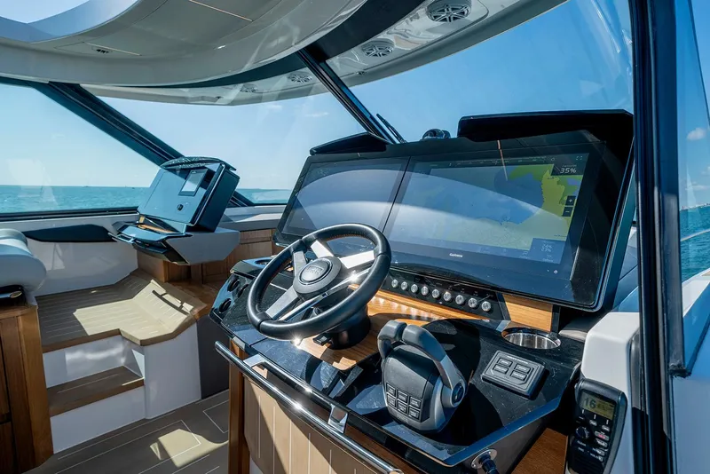 Slide: The Image of Control panel of 2024 Tiara Yachts EX 60 with joystick and Volvo Penta display. - 35