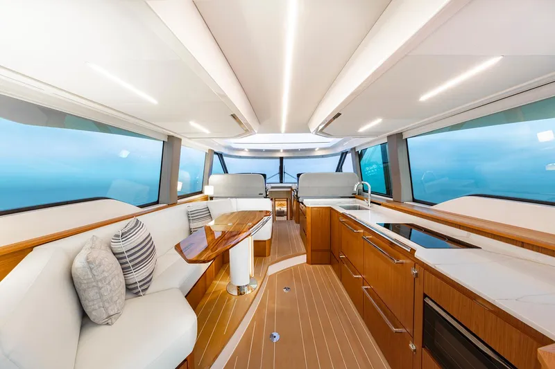 Slide: The Image of 2024 Tiara Yachts EX 60 helm with advanced navigation displays and steering wheel. - 37