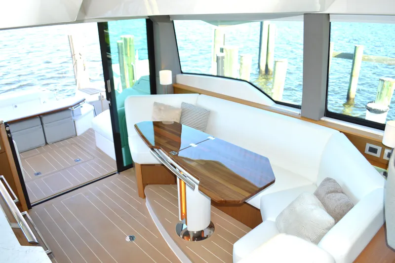Slide: The Image of Luxurious interior of 2024 Tiara Yachts EX 60 with elegant seating and wooden table. - 49