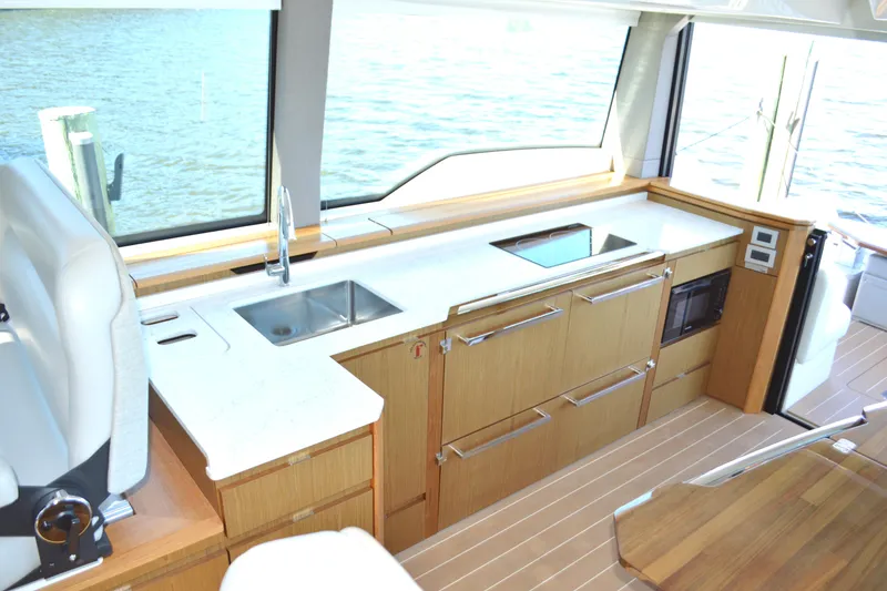 Slide: The Image of Luxurious 2024 Tiara Yachts EX 60 interior kitchen with modern appliances and sleek design. - 50