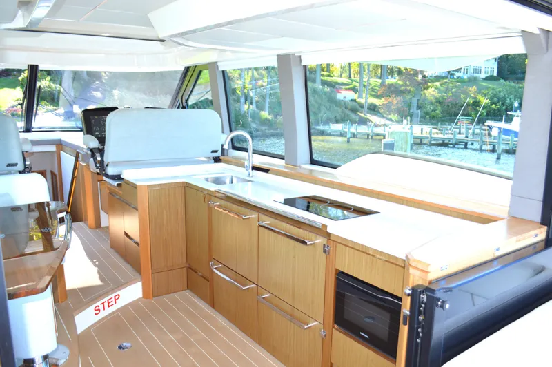 Slide: The Image of Luxurious interior of 2024 Tiara Yachts EX 60, featuring modern kitchen and panoramic windows. - 51
