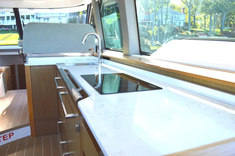 Slide: The Image of Luxurious kitchen interior of 2024 Tiara Yachts EX 60 with sleek countertops and modern appliances. - 52