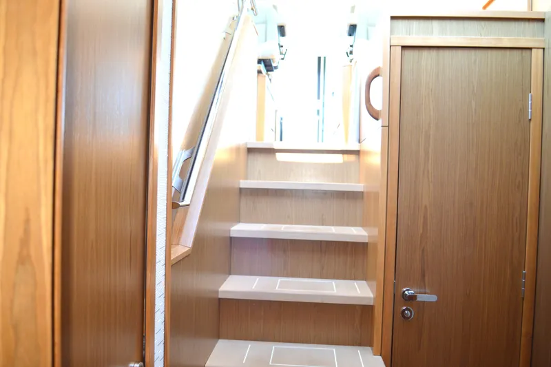 Slide: The Image of 2024 Tiara Yachts EX 60 interior staircase with wooden finish and modern design. - 55