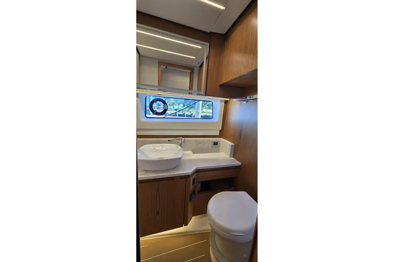 Slide: The Image of Luxurious bathroom interior of 2024 Tiara Yachts EX 60 with modern fixtures and wood accents. - 67