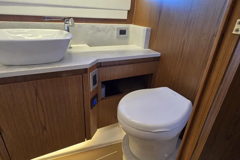 Slide: The Image of Luxurious bathroom in 2024 Tiara Yachts EX 60, featuring modern sink and toilet. - 69