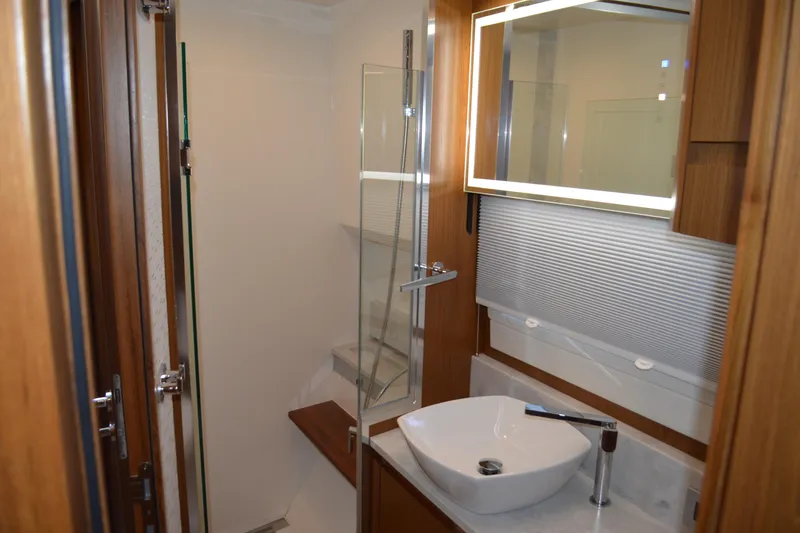 Slide: The Image of Luxurious bathroom interior of 2024 Tiara Yachts EX 60 with modern fixtures and elegant design. - 76