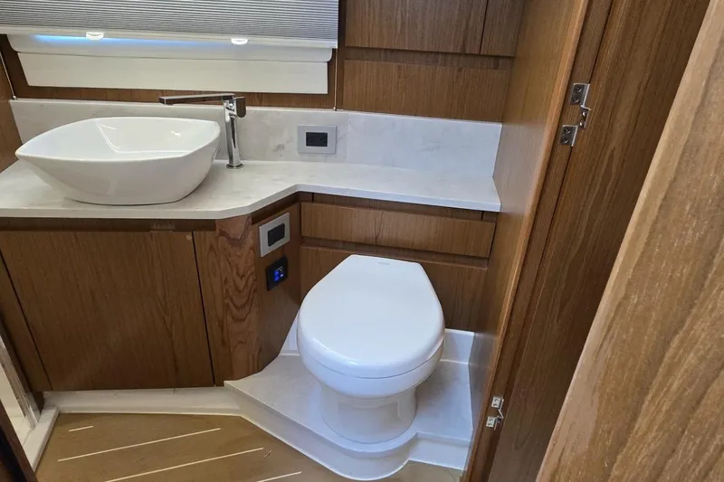 Slide: The Image of Luxurious bathroom in 2024 Tiara Yachts EX 60 with modern sink and toilet. - 78