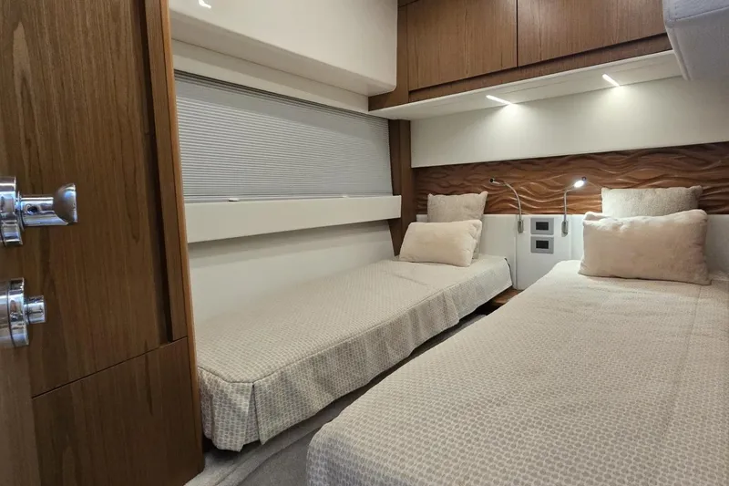 Slide: The Image of 2024 Tiara Yachts EX 60 interior cabin with twin beds and modern design. - 81