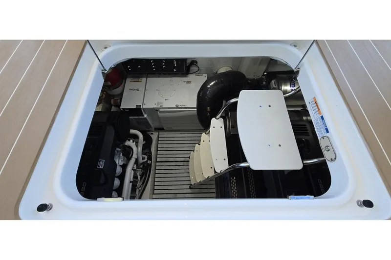 Slide: The Image of Engine compartment of 2024 Tiara Yachts EX 60, showcasing mechanical components and access ladder. - 87