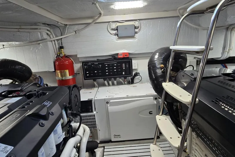 Slide: The Image of Engine room of 2024 Tiara Yachts EX 60 with equipment and fire extinguisher. - 88