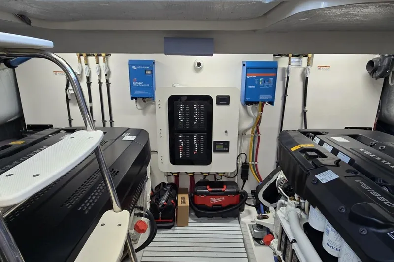 Slide: The Image of Engine room of 2024 Tiara Yachts EX 60, featuring advanced equipment and control panels. - 89