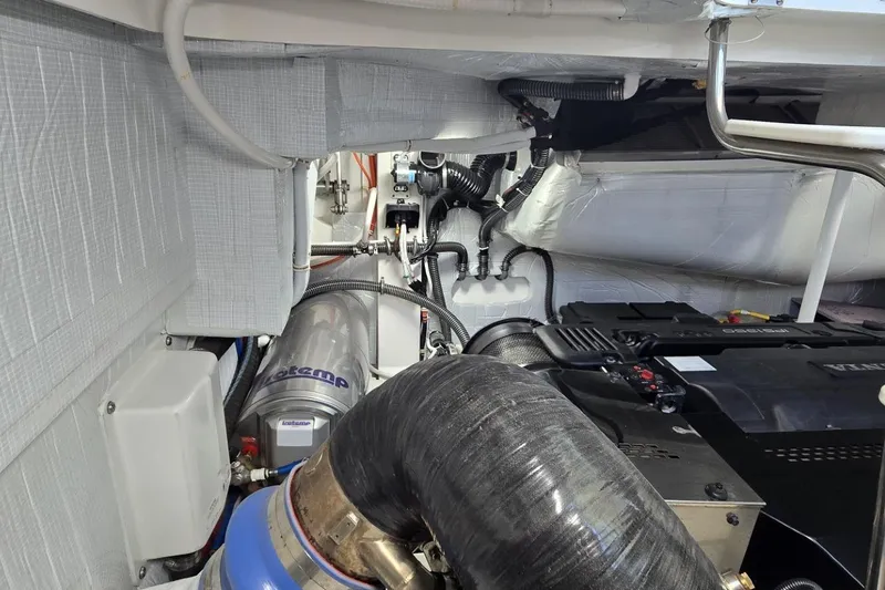 Slide: The Image of Engine room of 2024 Tiara Yachts EX 60, showcasing mechanical components and systems. - 92